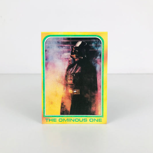 Front image of a 1980 Star Wars Darth Vader trading card with the title "The Ominous One" along the bottom.