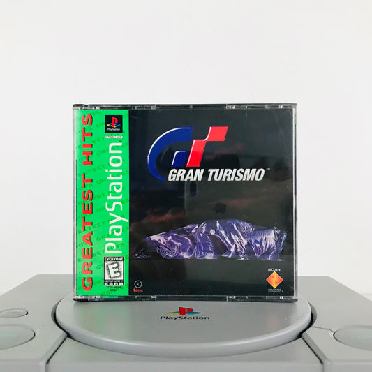 The 1998 Sony Playstation classic video game Gran Turismo, displayed on top of an original PS1 game system.