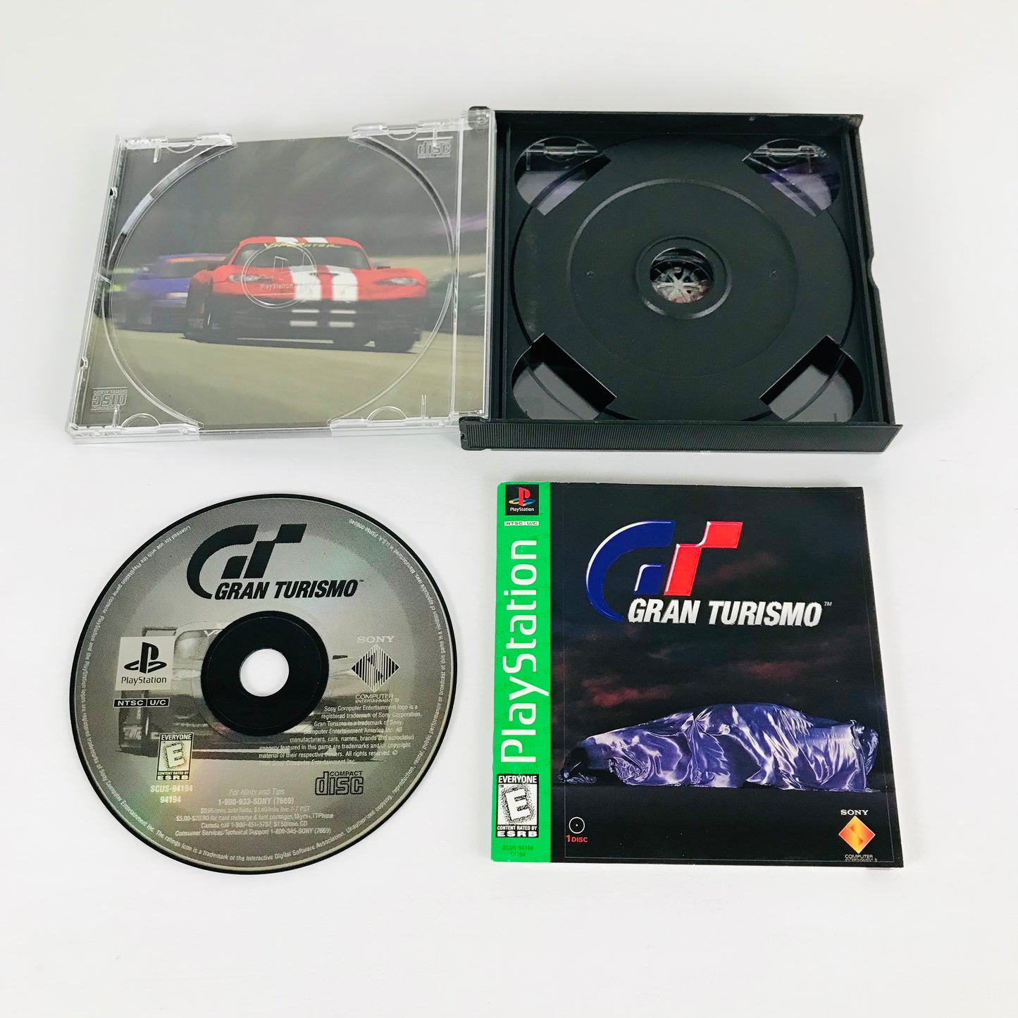 The jewel case, game disc, and instructions booklet for the Sony PS1 game, "Gran Turismo".