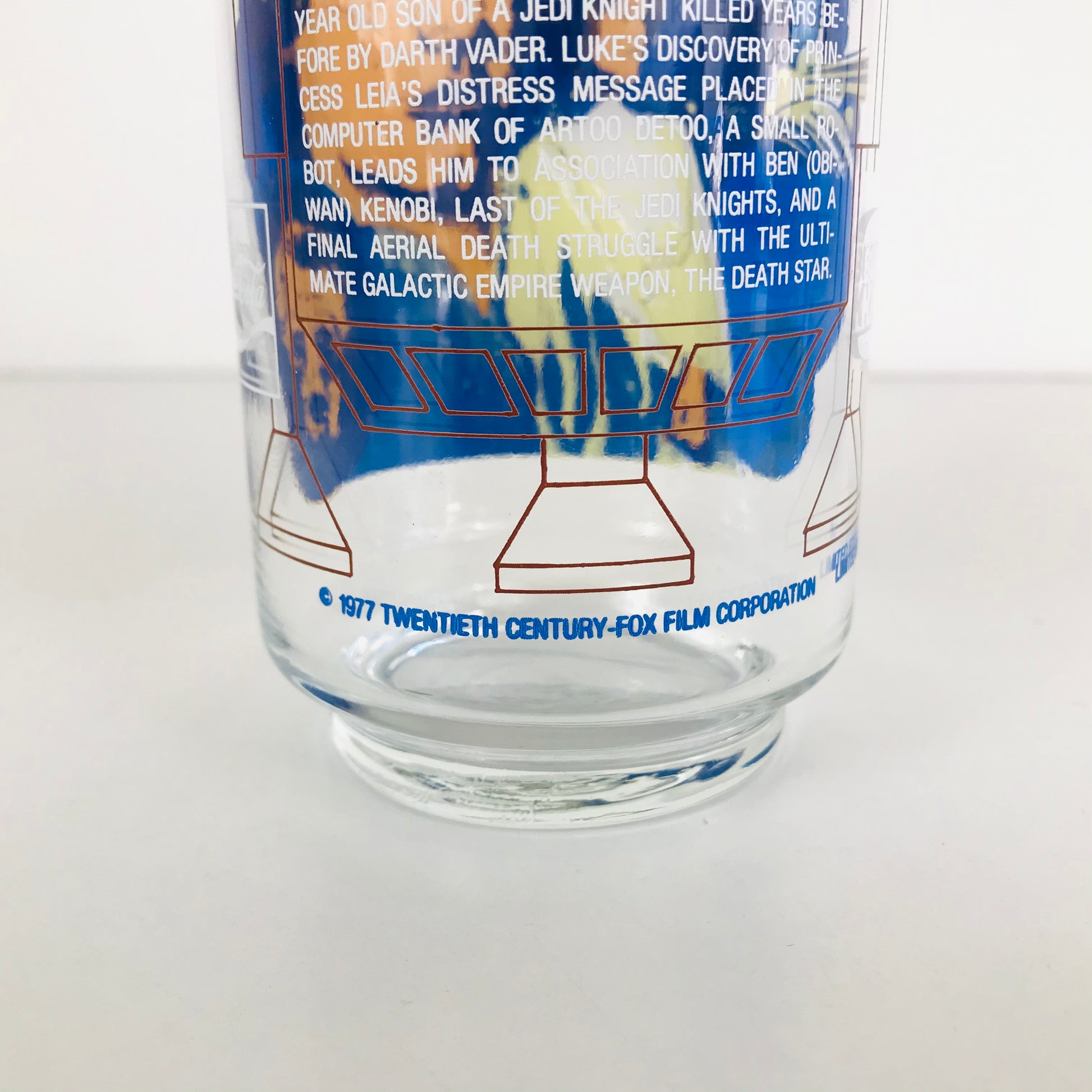 Back of the glass artwork of R2-D2's legs with the text "1977 Twentieth Century-Fox Film Corporation" underneath.