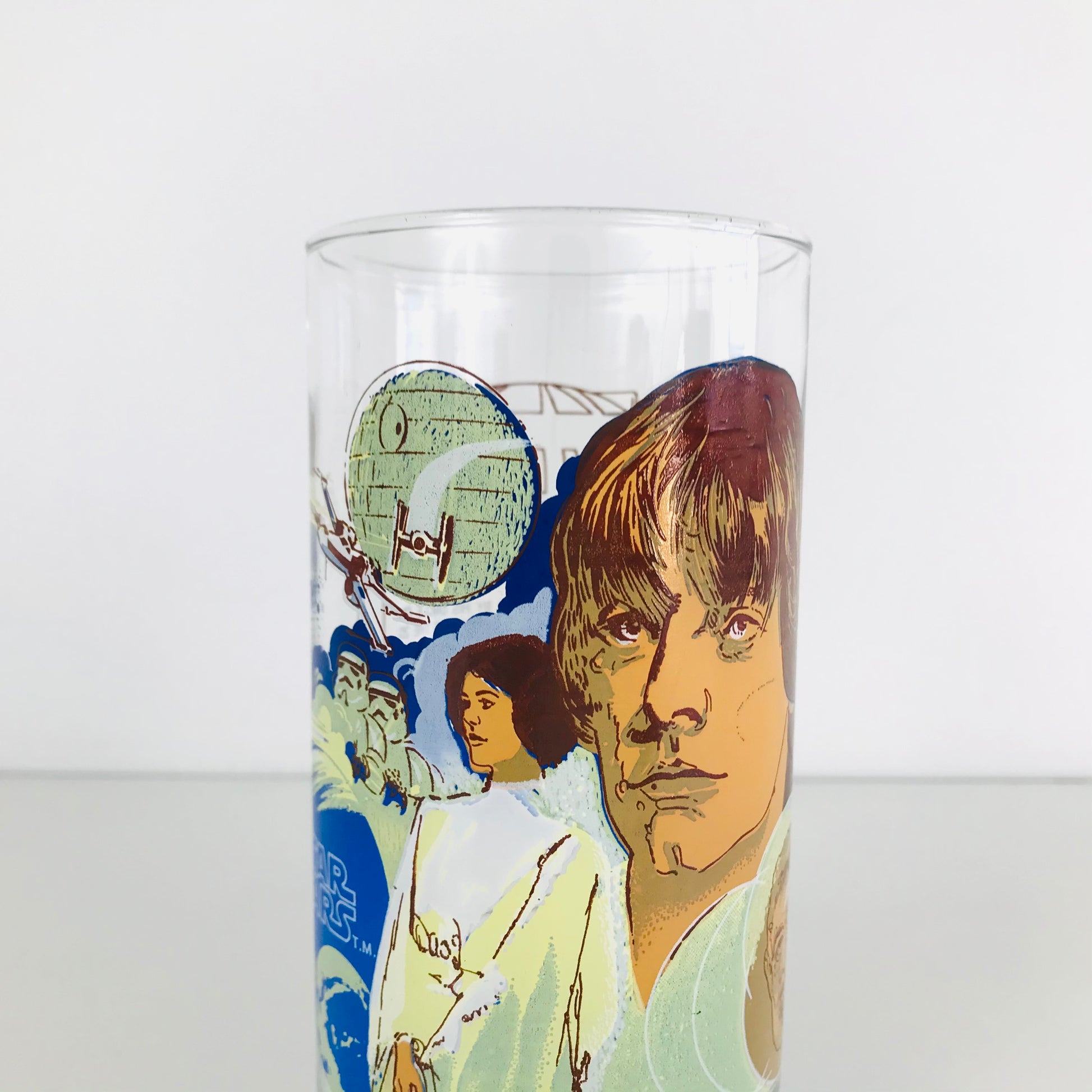 Top of a Star Wars glass tumbler showing detailed artwork of an X-Wing Fighter battling a TIE Fighter in front of the Death Star.