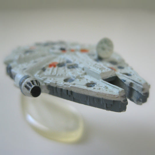 A super close up view of a miniature Star Wars Millennium Falcon spaceship toy.