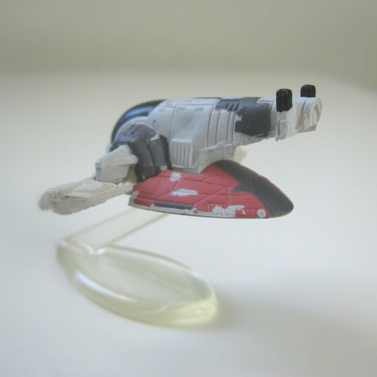 Side view of a miniature Star Wars Slave I spaceship toy, shown on a plastic display stand.