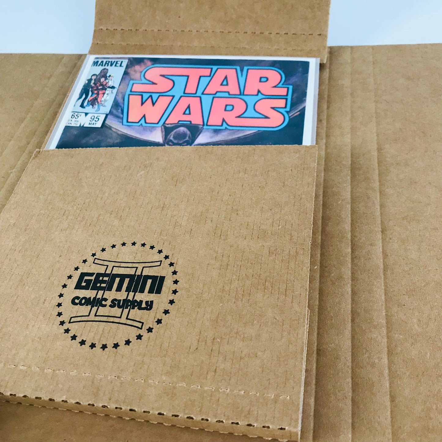 An image showing a vintage comic book wrapped up securely in a Gemini cardboard comic book mailer.