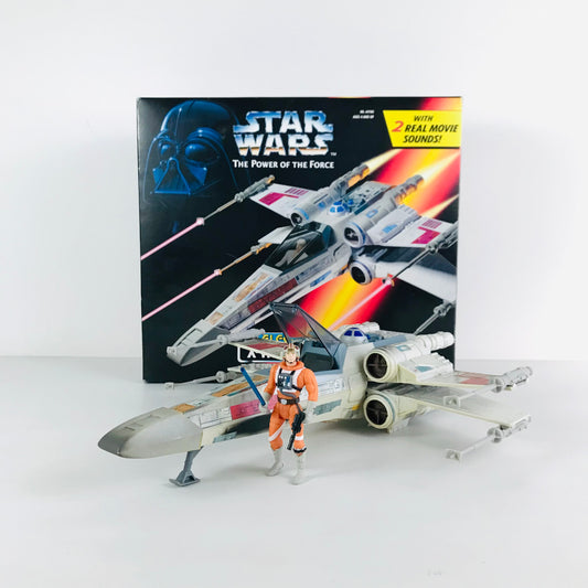 Toy versions of Luke Skywalker and his X-Wing Fighter vehicle displayed in front of the original box.