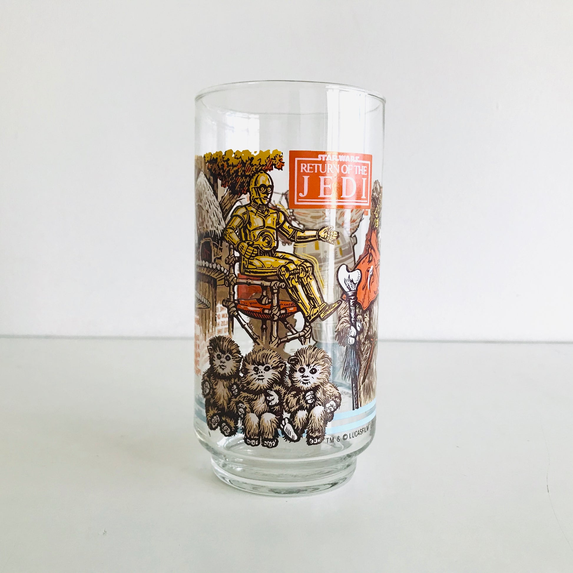 Star Wars glass tumbler graphic of C-3PO levitating from his wooden chair in front of 3 baby Ewoks