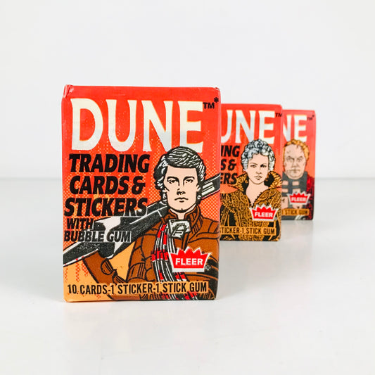 Multiple packs of 1984 Dune trading card packs--displayed upright in a row