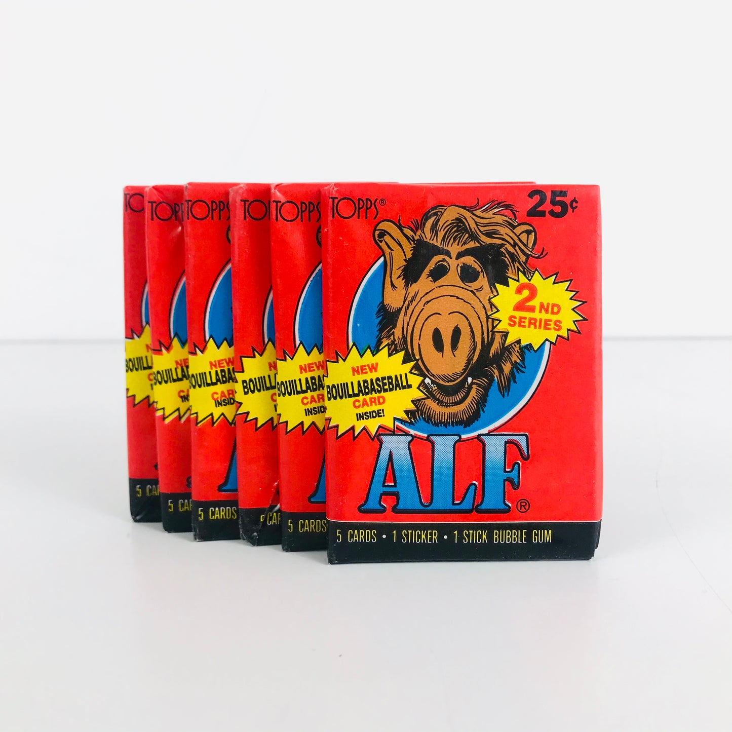 Multiple 1980s Alf trading card packs displayed in a row.