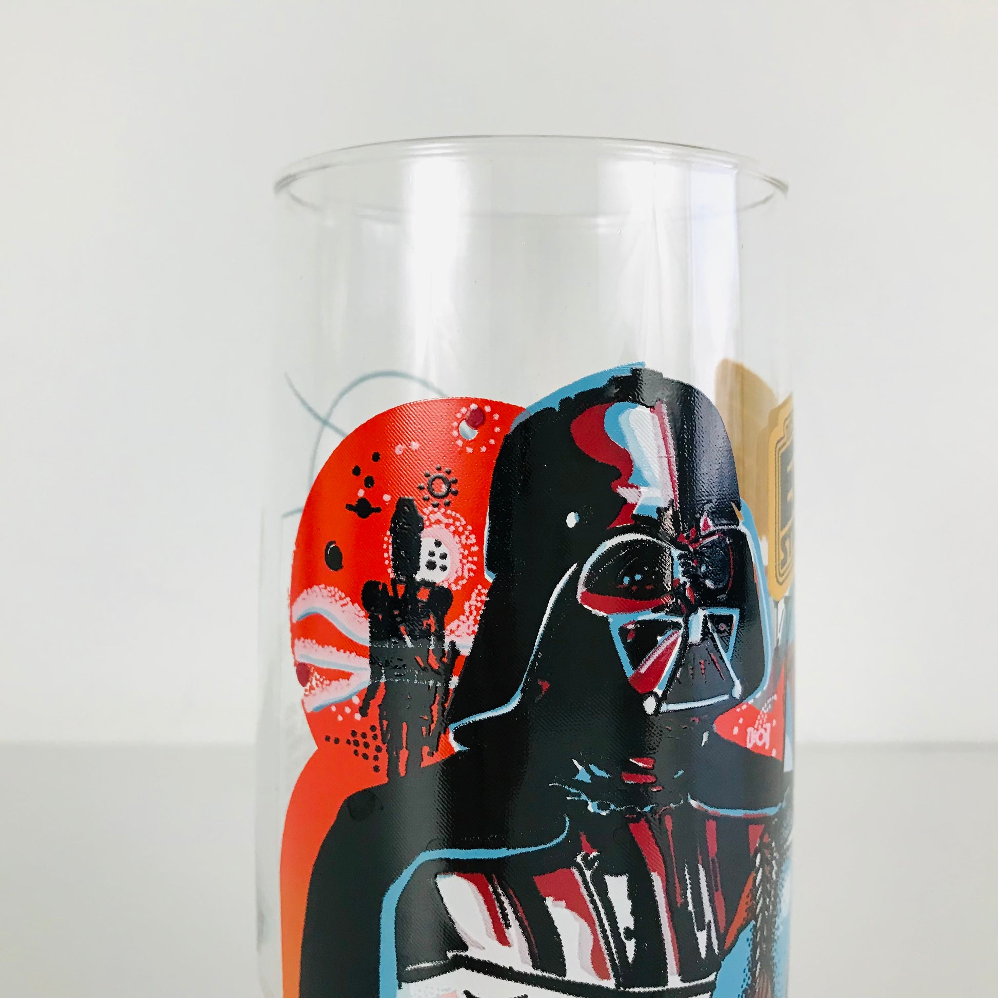 Top half of a vintage Star Wars glass tumbler featuring Darth Vader and the assassin droid / bounty hunter known as IG-88