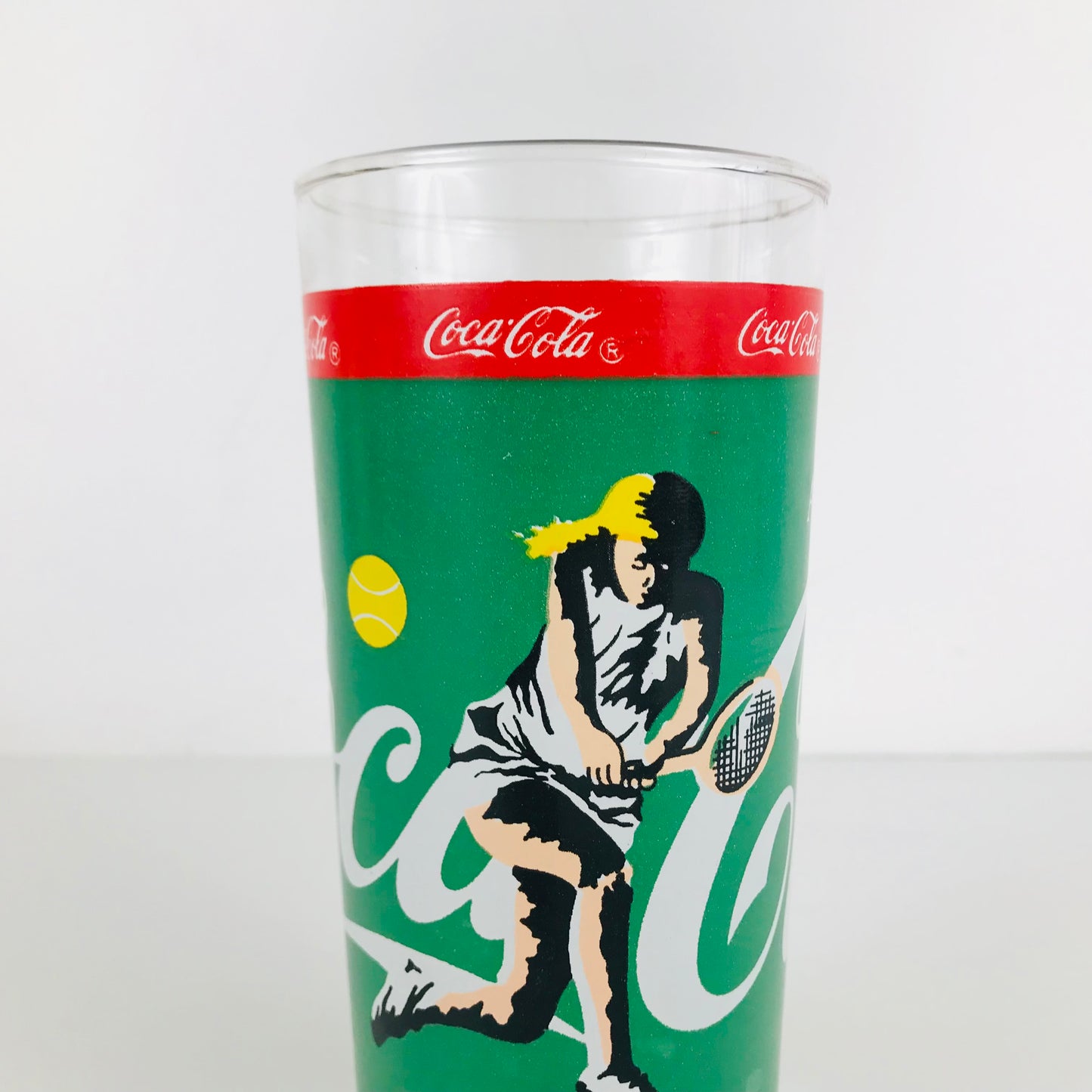 Coca Cola highball style drinking glass with a tennis-themed graphic print.