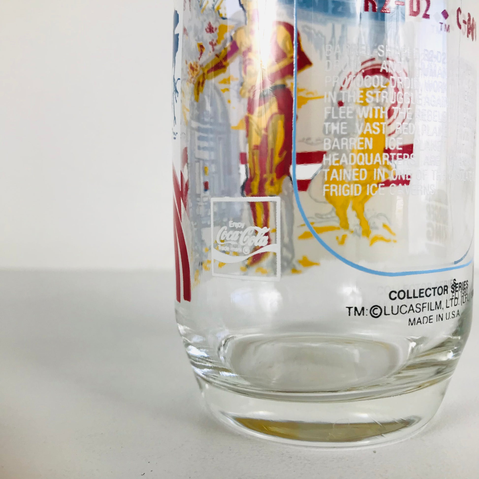 Close up image of an "Enjoy Coca-Cola" emblem on a vintage Star Wars Burger King glass.