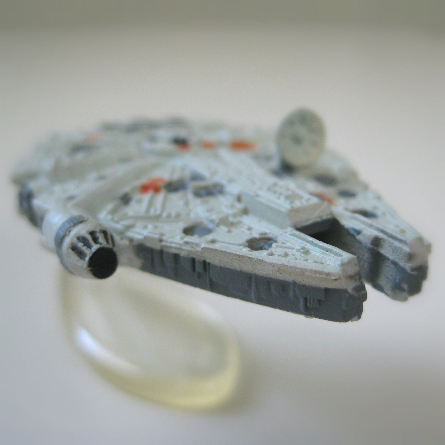 A super close up view of a miniature Star Wars Millennium Falcon spaceship toy.