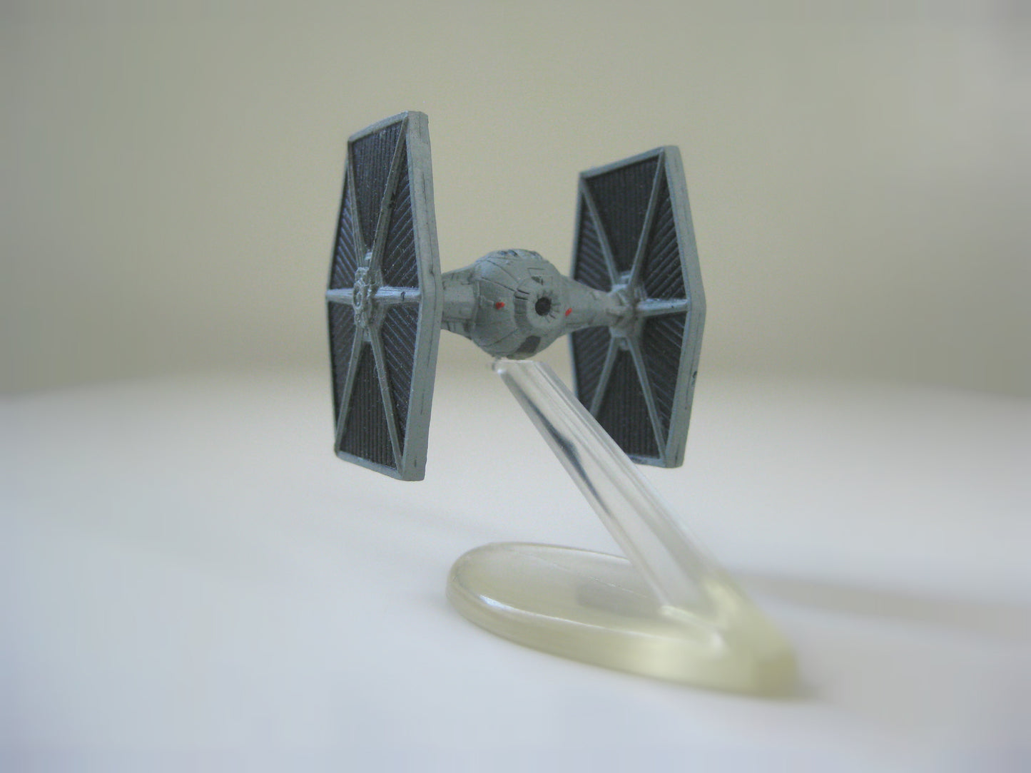 Back view of a super tiny Star Wars Imperial TIE Fighter scale model.