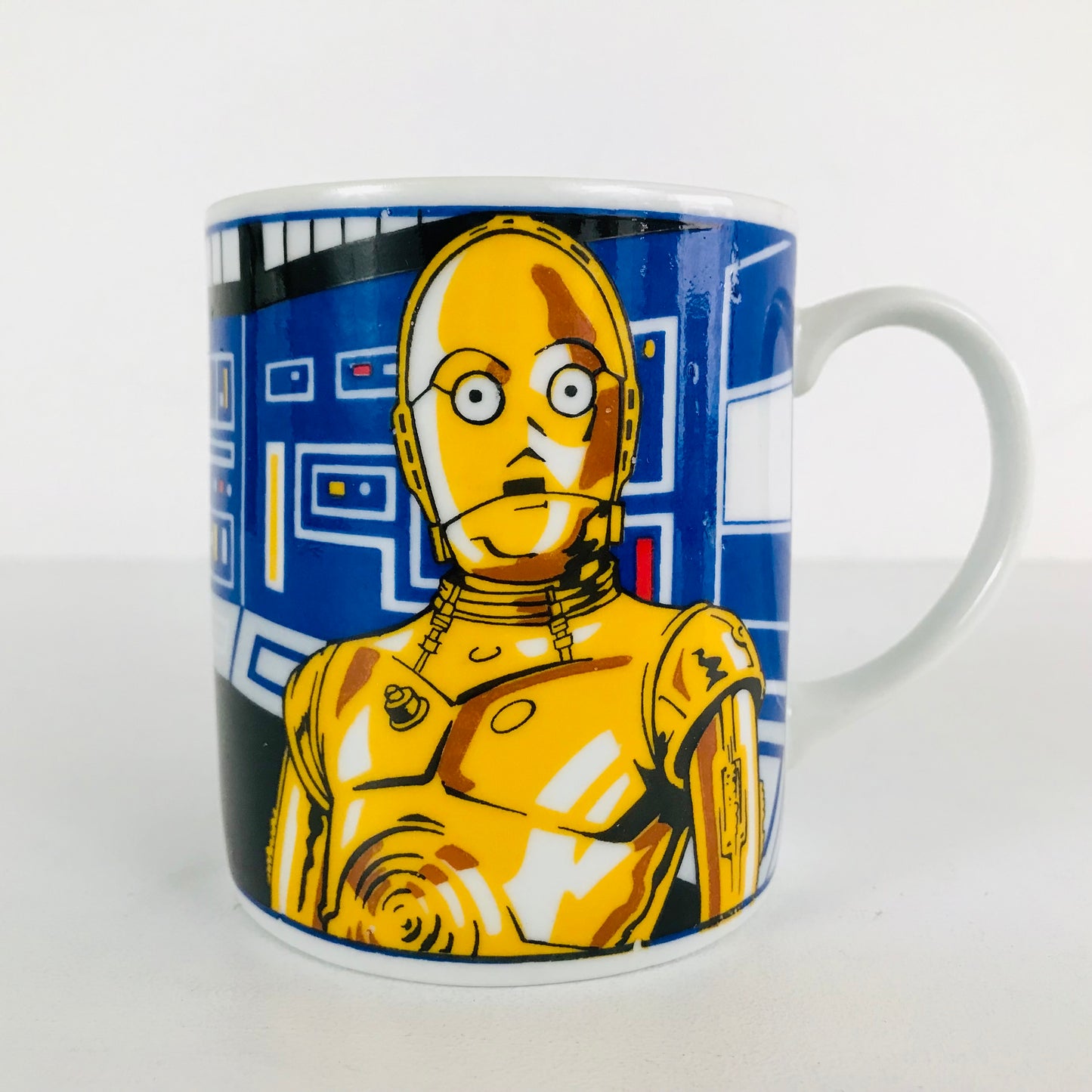 C-3PO is fluent in over 3 million forms of communication--he also looks marvelous on the side of this 1980s Sigma Star Wars coffee mug!