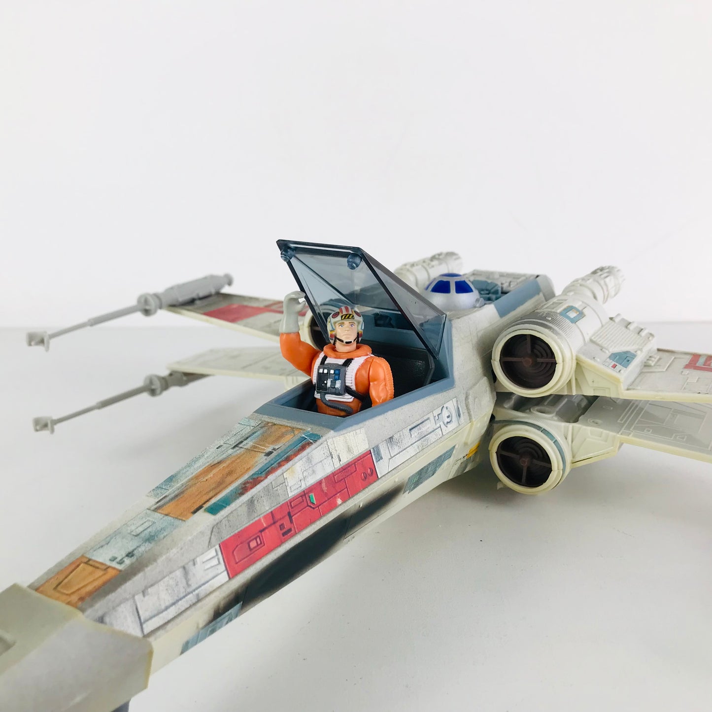 Luke Skywalker raising the cockpit door of his X-Wing Fighter vehicle.