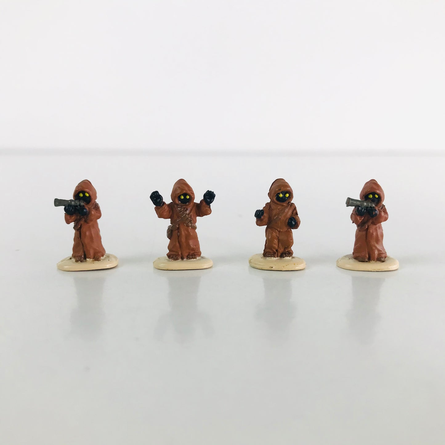 Miniature Jawa figurines posed in a row